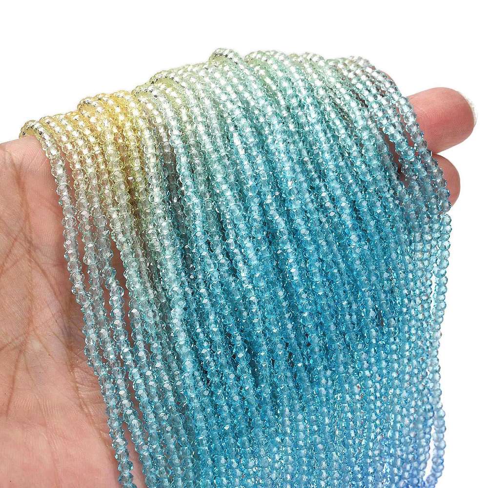 Transparent faceted glass rondelle beads strand, aqua, teal, blue with light yellow edges.