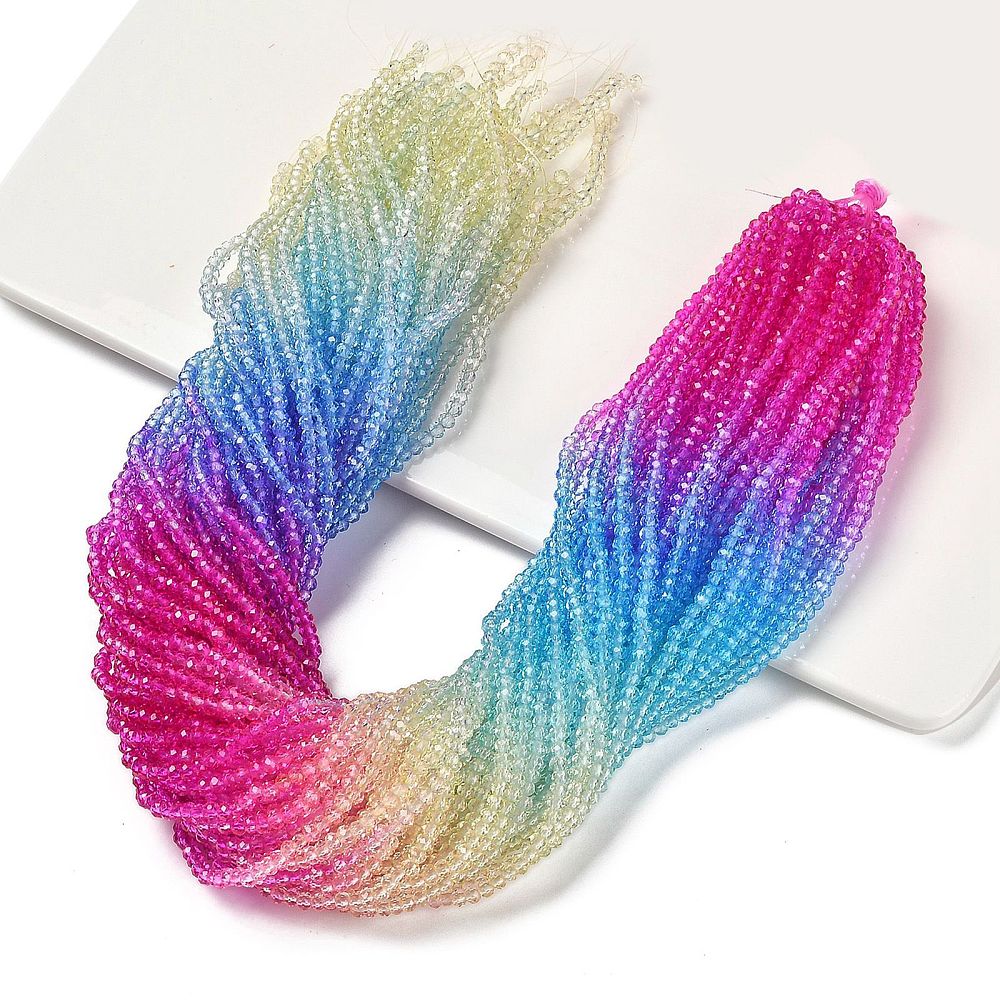 Multi-color faceted glass rondelle beads strand on card, pink-to-blue with teal tones