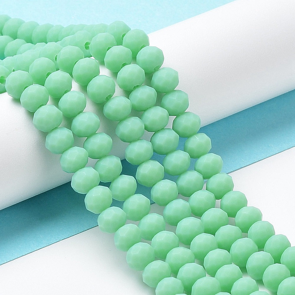 Spring green frosted glass rondelle bead strand, side view with translucent beads