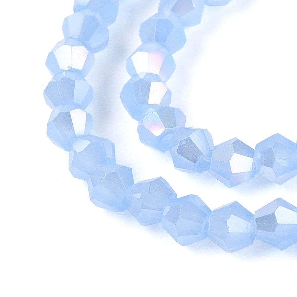 Cornflower blue faceted glass bicone beads with AB iridescence, angled view