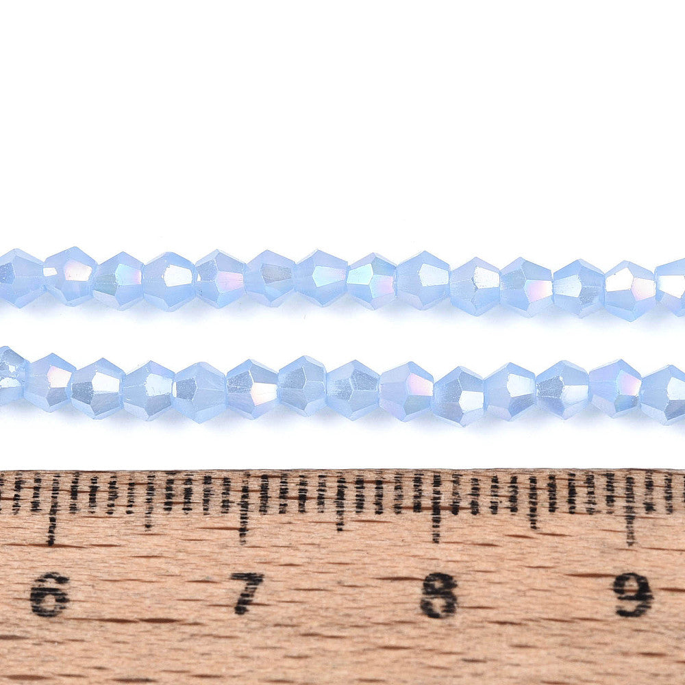 3mm cornflower blue AB electroplated glass bicone beads on a ruler