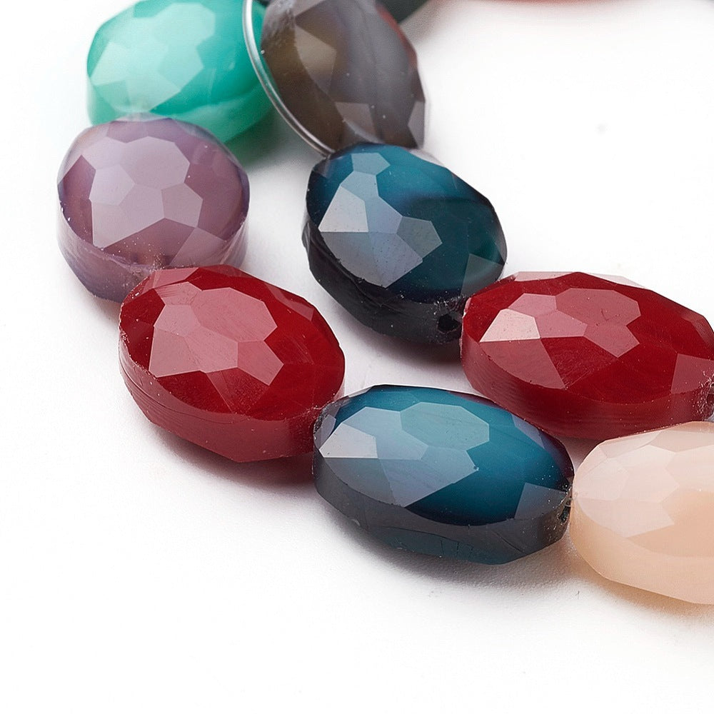 Close view of mixed-color faceted oval glass beads with pearl luster shine