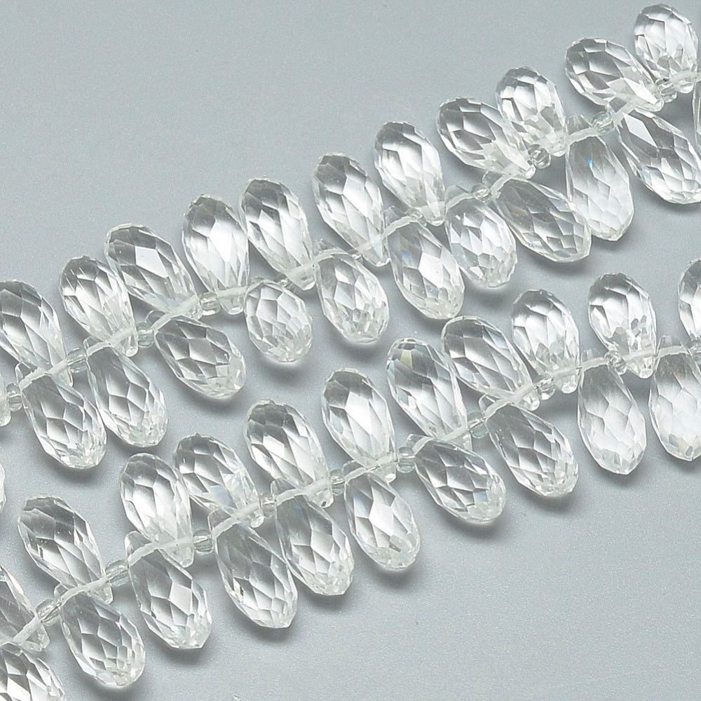 Clear faceted teardrop glass beads, drilled holes, close-up