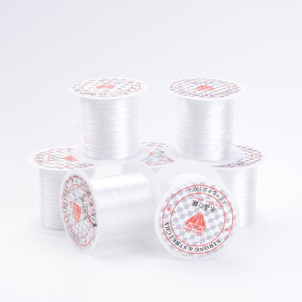 White flat elastic crystal string on multiple spools for stretch bracelets