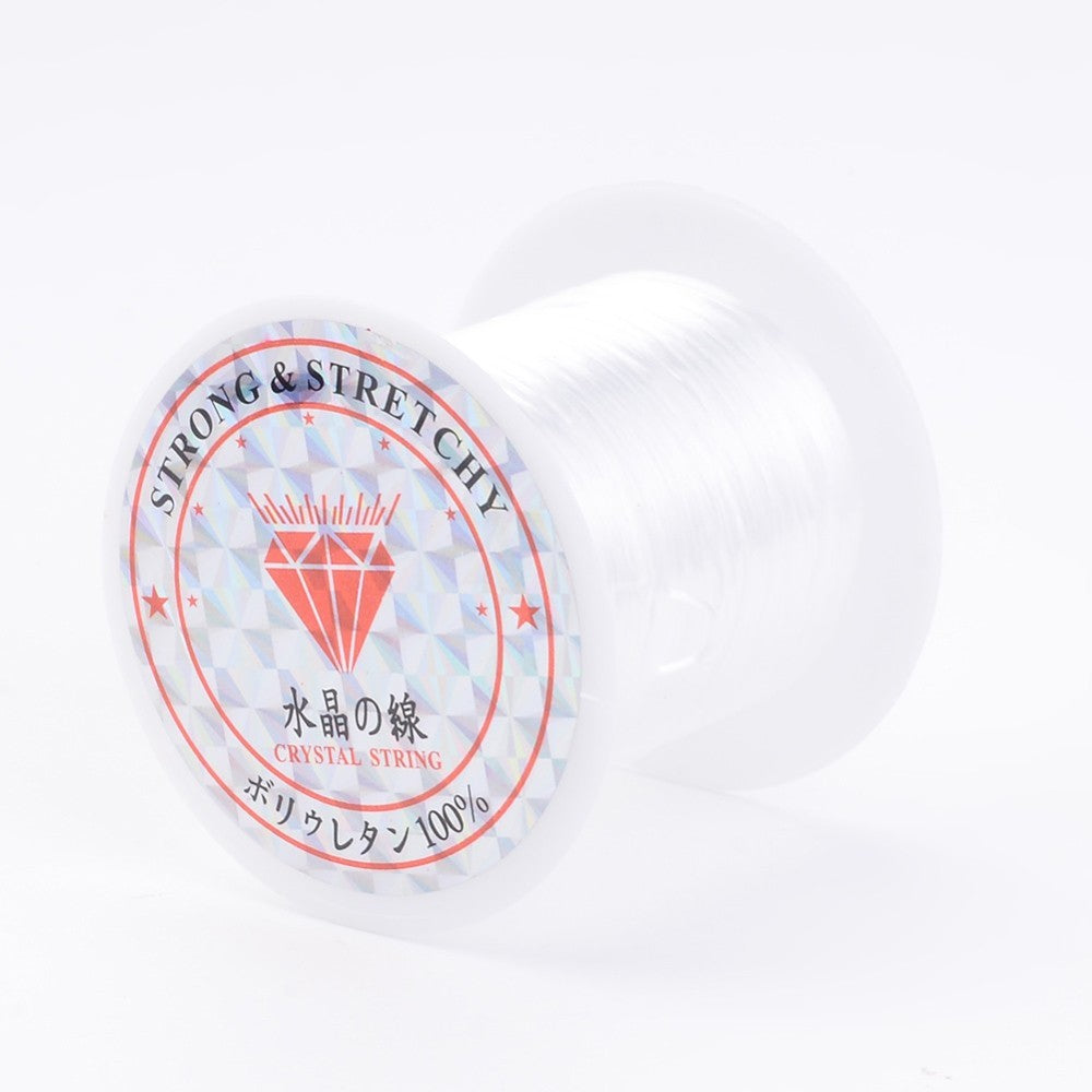White flat elastic crystal string spool with printed label