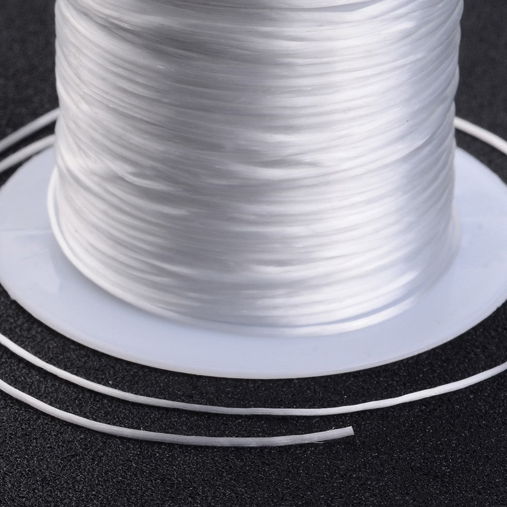 White flat elastic crystal string strand close-up