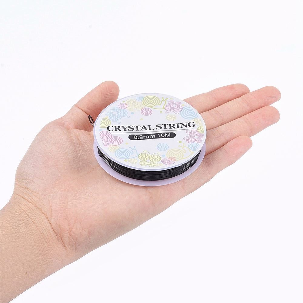 Black crystal string spool in hand, 0.8mm thin elastic beading cord.