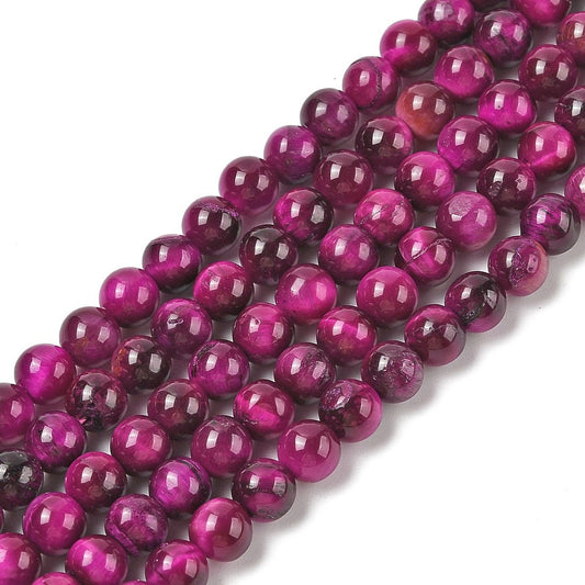Dyed purple round beads strand with a glossy finish and reflective highlights