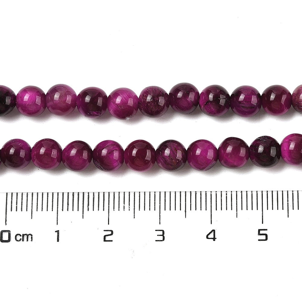 Purple round beads strand with size ruler beneath, glossy finish