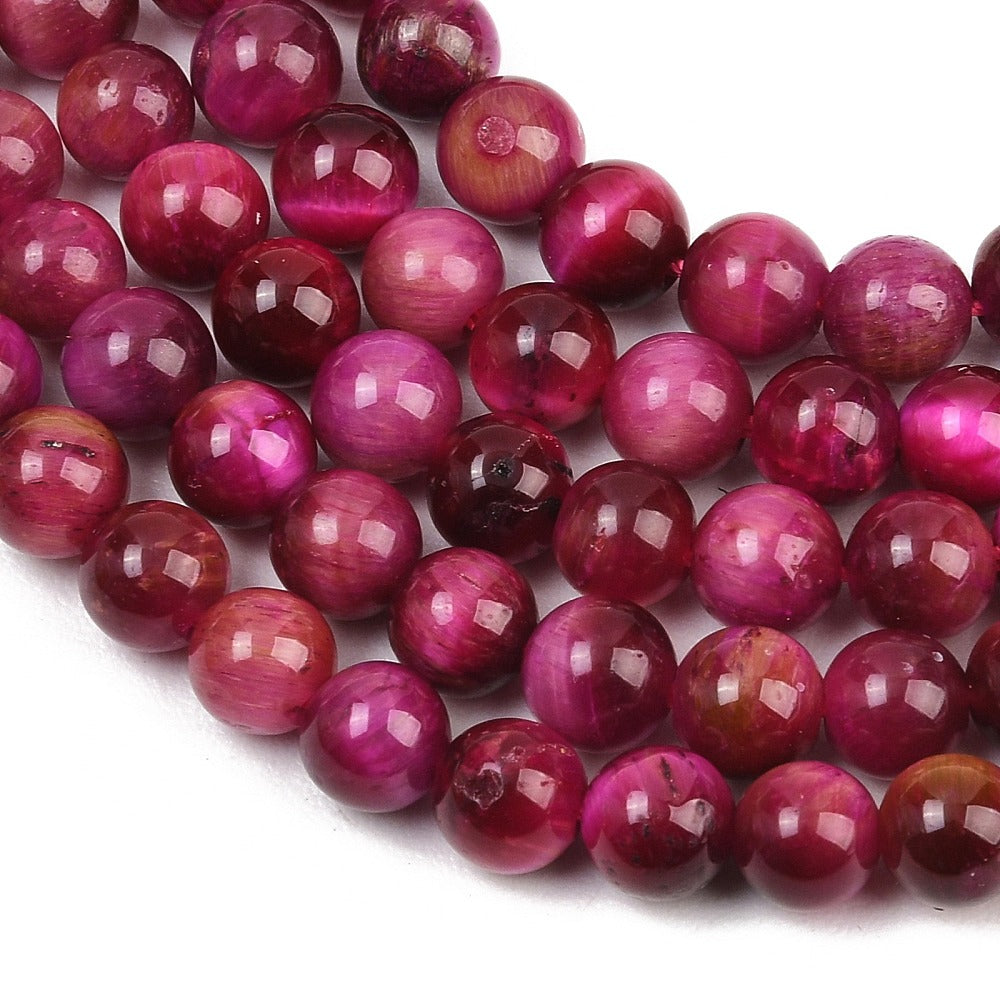 Purple round beads close-up with mixed darker and brighter tones, glossy highlights