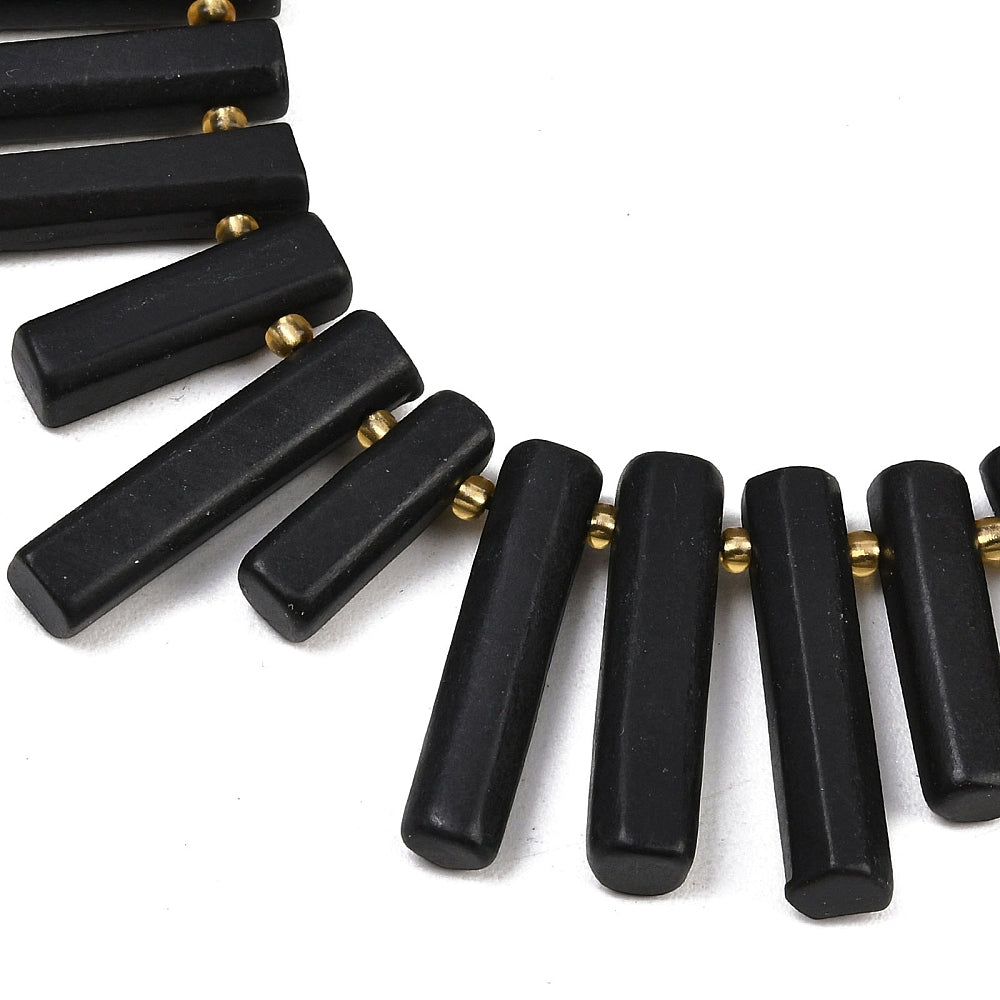 Black rectangular column beads with small gold-tone end accents