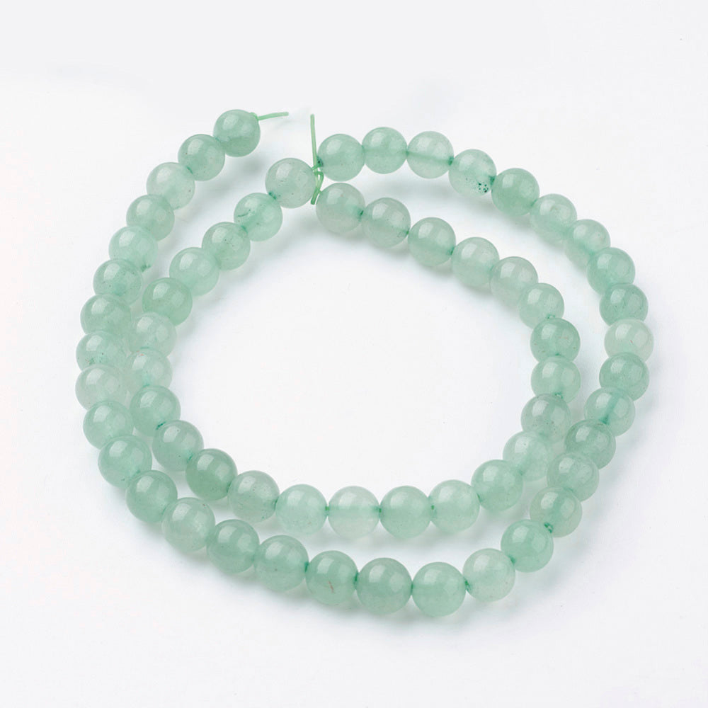 Green round gemstone bead strand looped in a circle with two ends