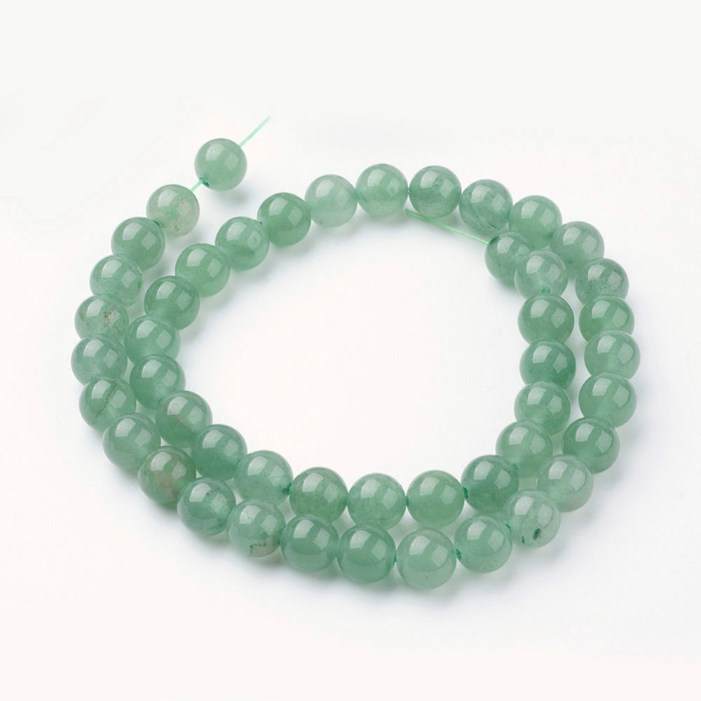 Green round gemstone beads strand looped around with a curved shape