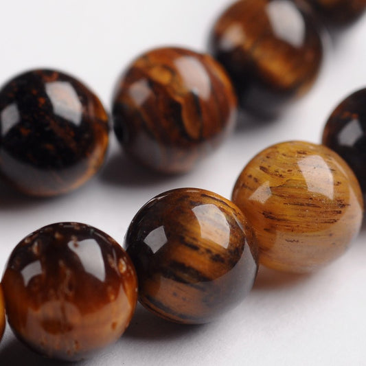 Round tiger eye gemstone beads in amber and dark brown, glossy facets