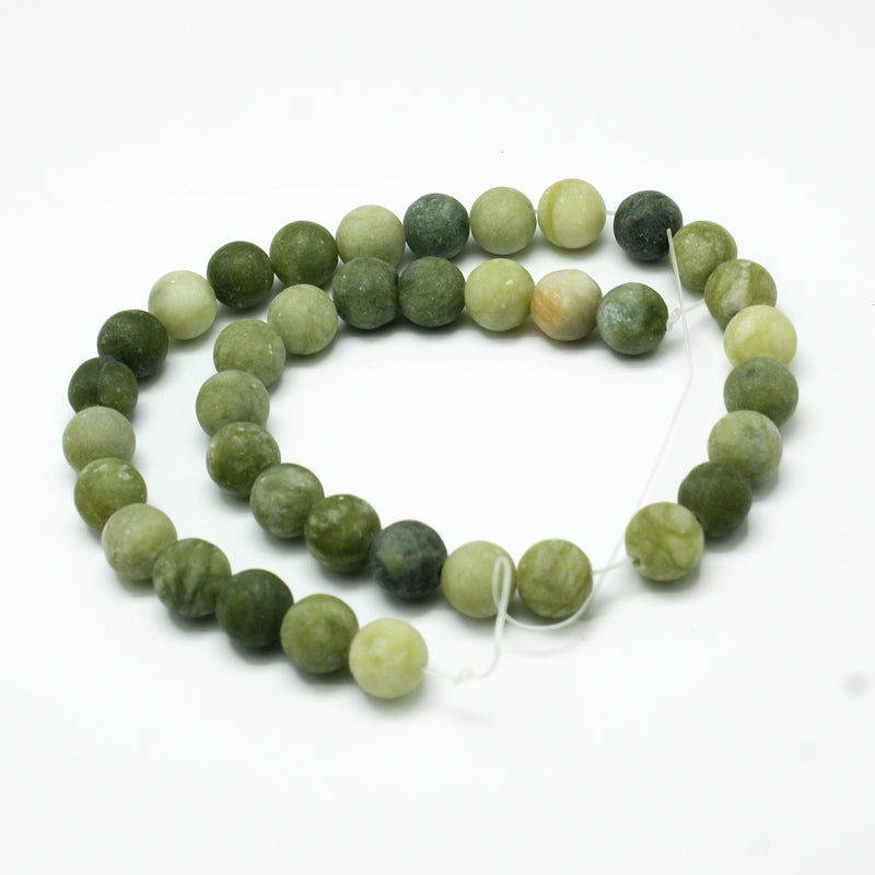 Strand of round green jade beads with frosted finish and visible string loop