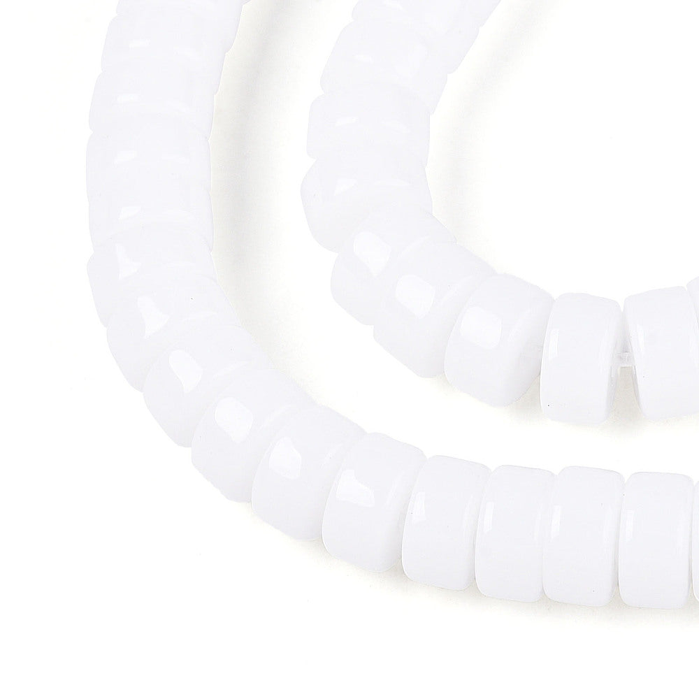 White opaque glass flat round beads strand, close-up of bead faces and holes