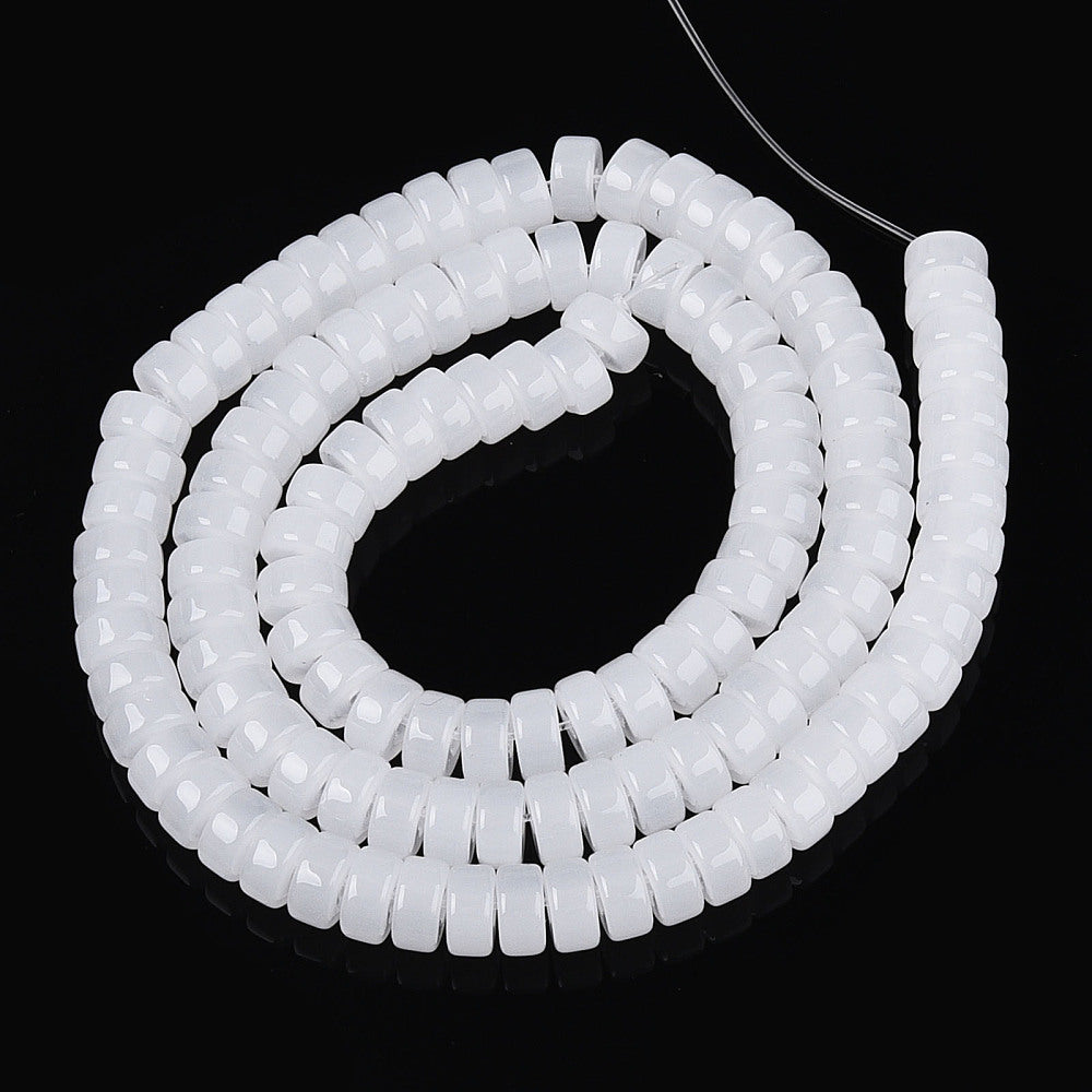 White flat round bead strand coiled with clear string loop
