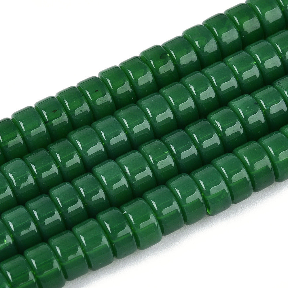 Green flat round bead strand, glossy finish, close-up of bead surfaces