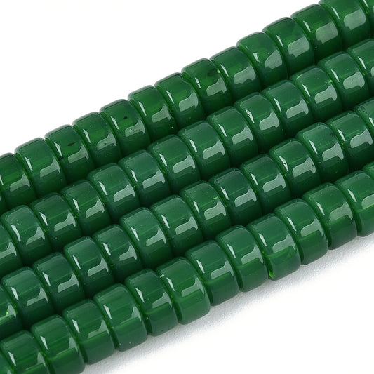 Green flat round bead strand, glossy finish, close-up of bead surfaces
