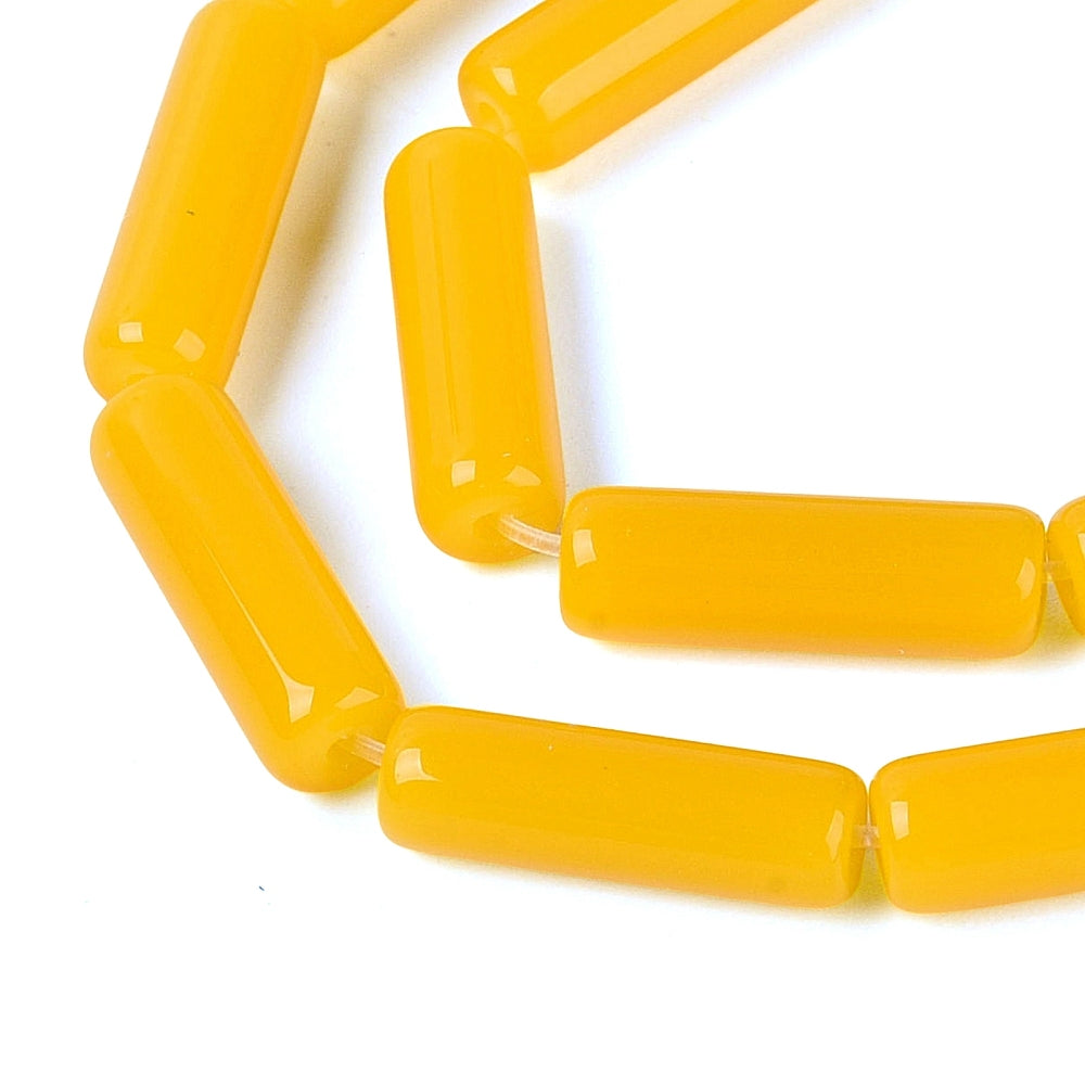 Gold yellow tube bugle beads with glossy finish, close-up strand segment