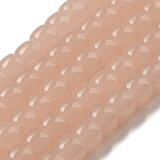 Salmon pink barrel glass beads strand, faceted oval barrel beads close-up