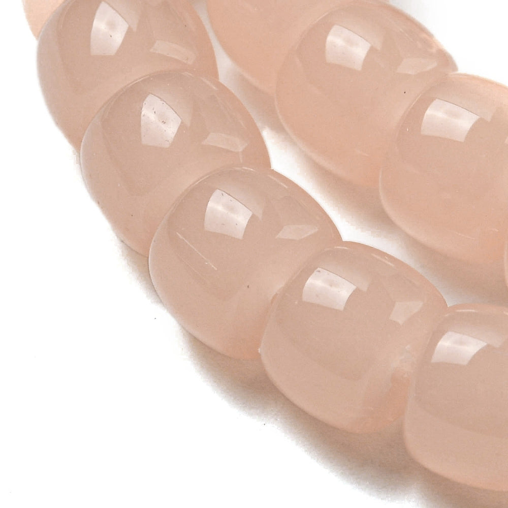 Salmon pink barrel glass beads strand, close-up of faceted bead segments