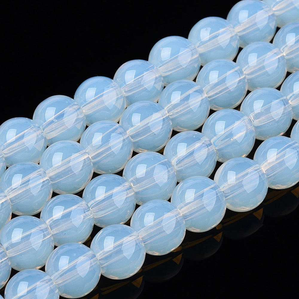 Transparent glass round beads strand, light blue opal-like, close-up row of beads