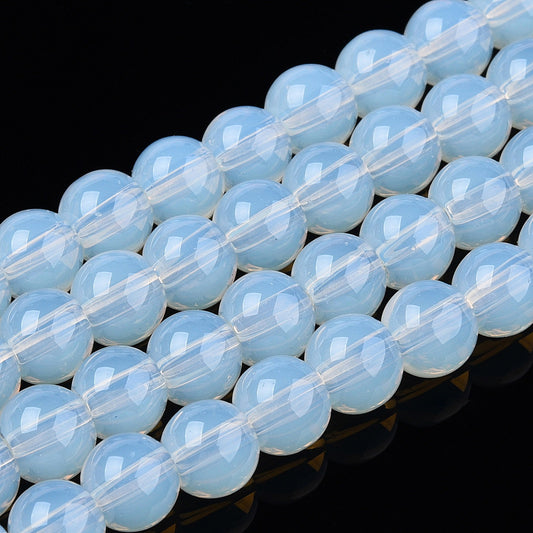 Transparent glass round beads strand, light blue opal-like, close-up row of beads
