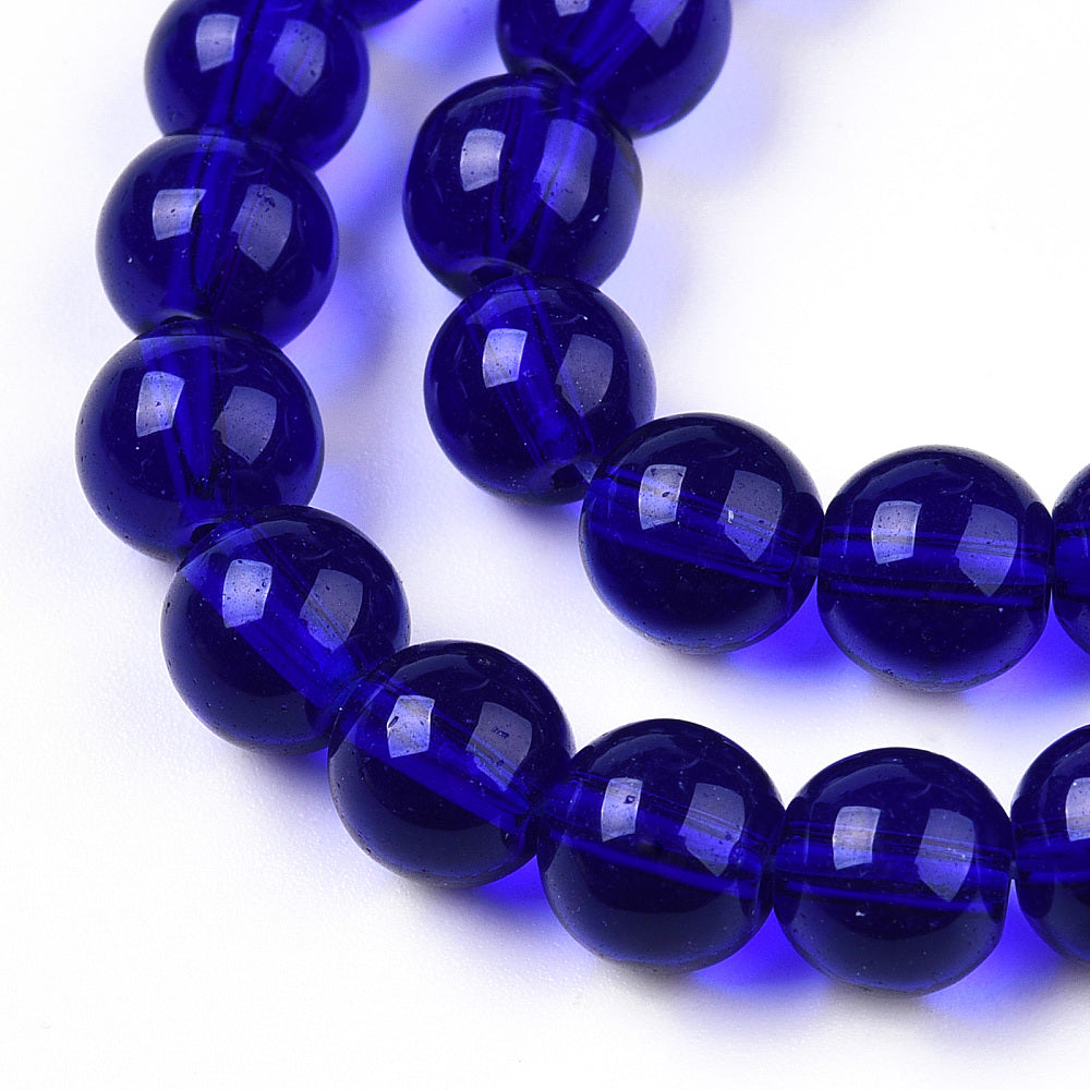 Dark blue transparent glass round beads strand, close view of glossy beads, 8–8.5mm