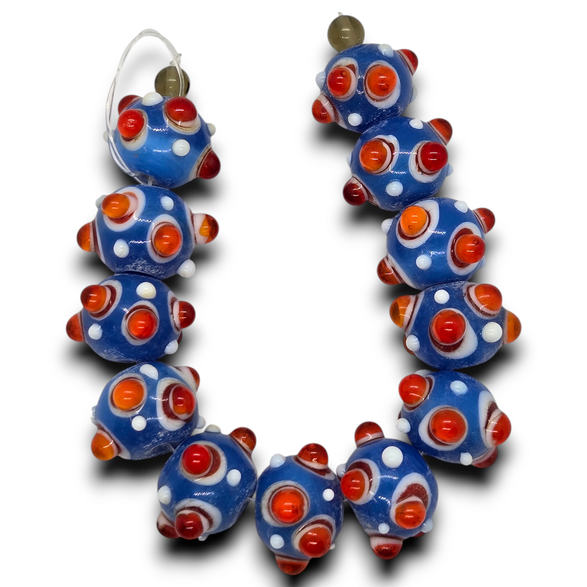 Blue glass rondelle beads strand with raised dot pattern, orange and red accents