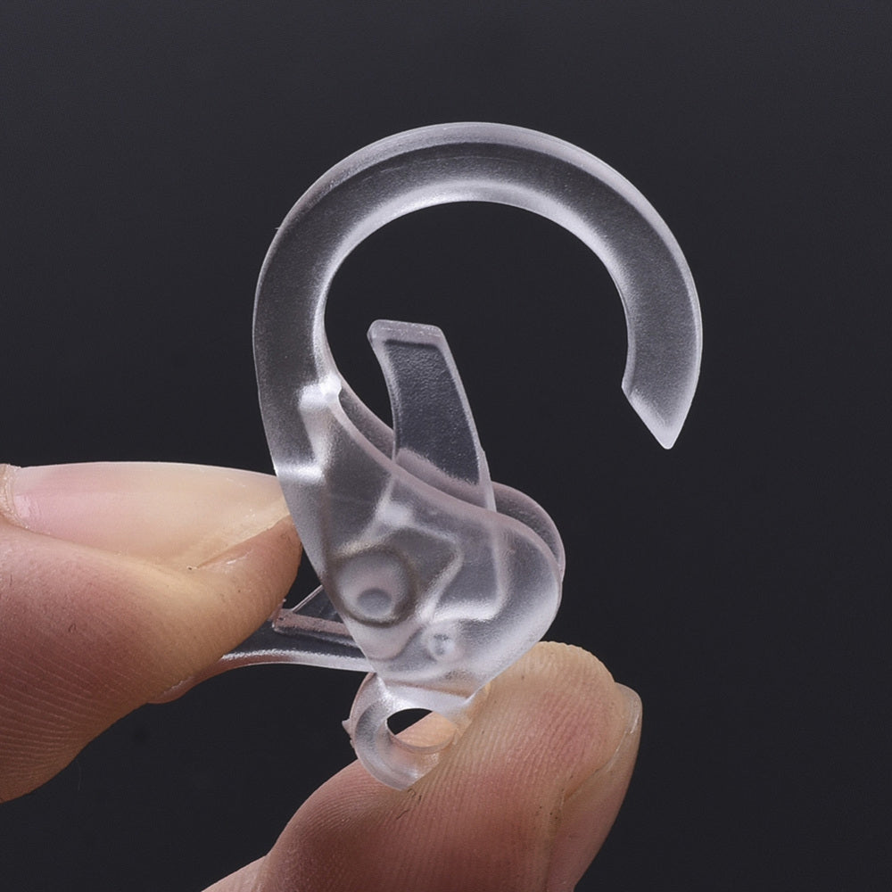 Clear plastic lobster claw clasp, close-up of oval ring and snap button