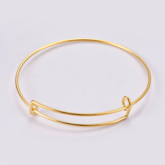 Gold alloy bangle with two stacked wire hoops and small side clasp