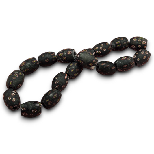 Matte vintage glass barrel beads with dark base and colorful millefiori dot pattern.