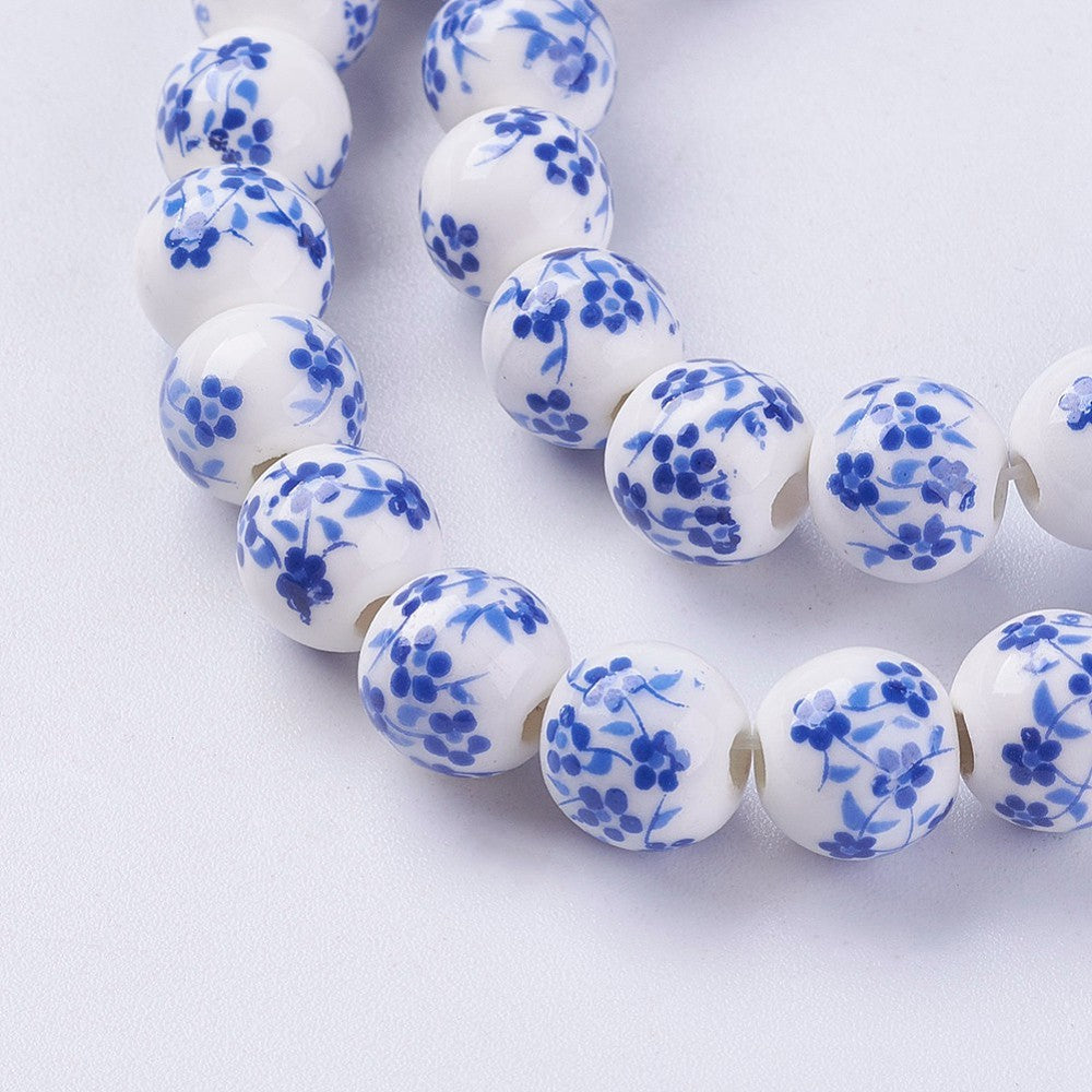 Porcelain round beads strand, white with blue daisy-like flower pattern