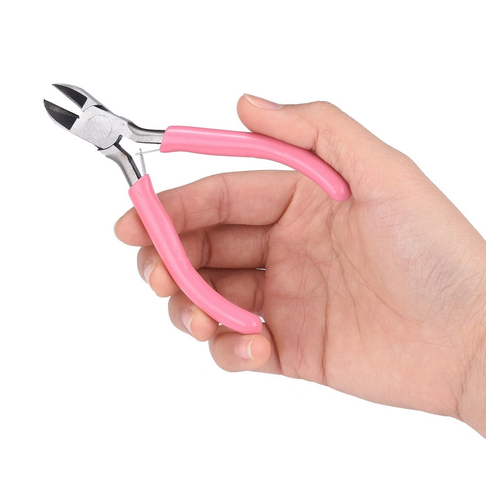 Side-cutting pliers with pink rubber handles held in a hand