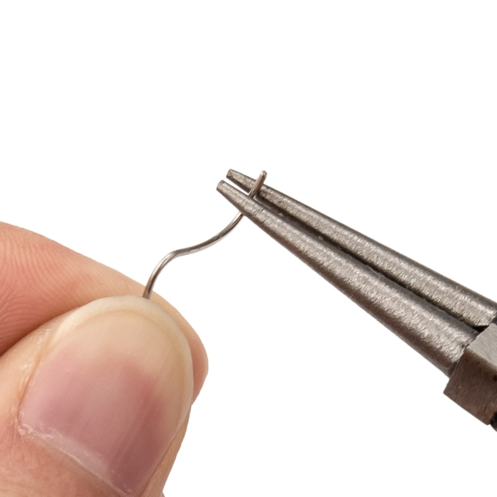 Close-up of round nose plier tips holding a small wire loop