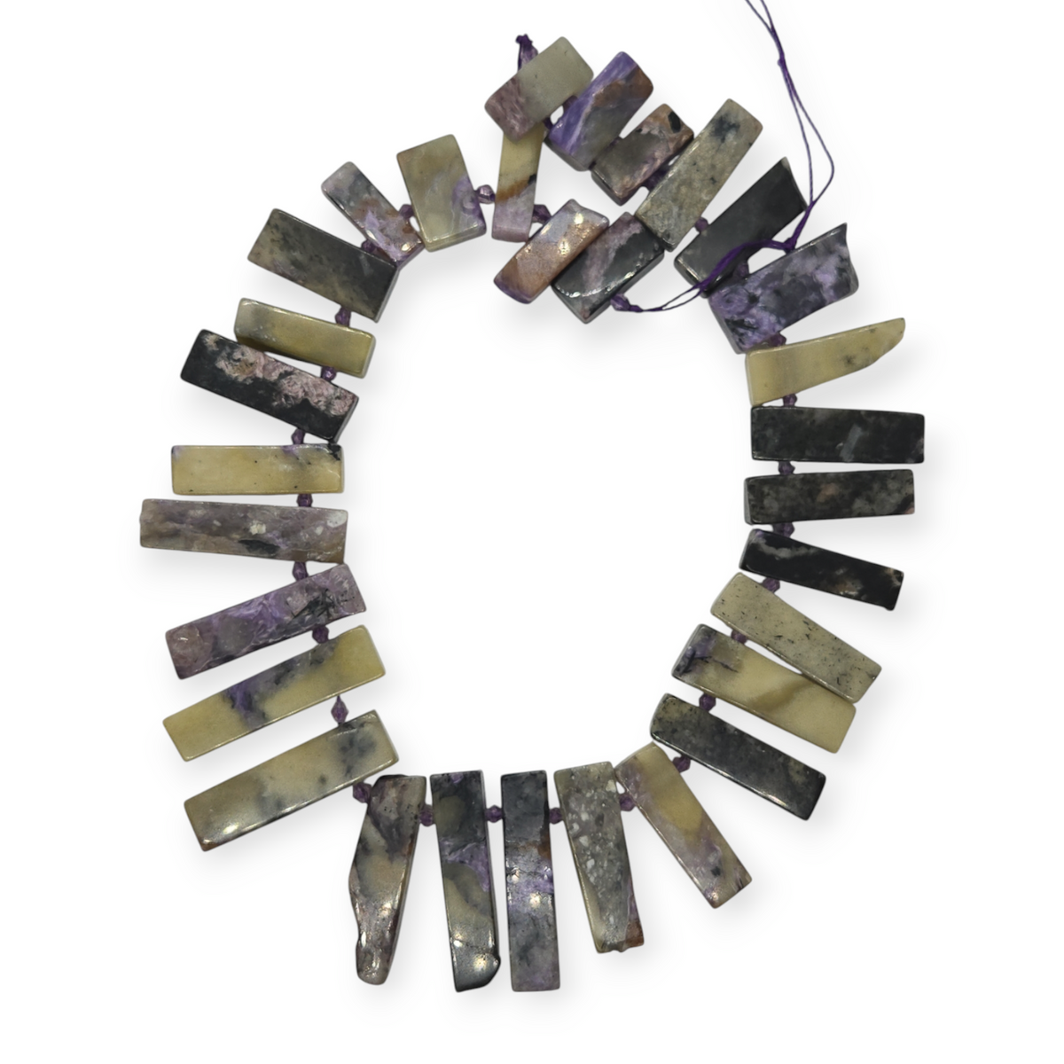 Charoite spike bead strand arranged in a circle; purple, black, and olive bars