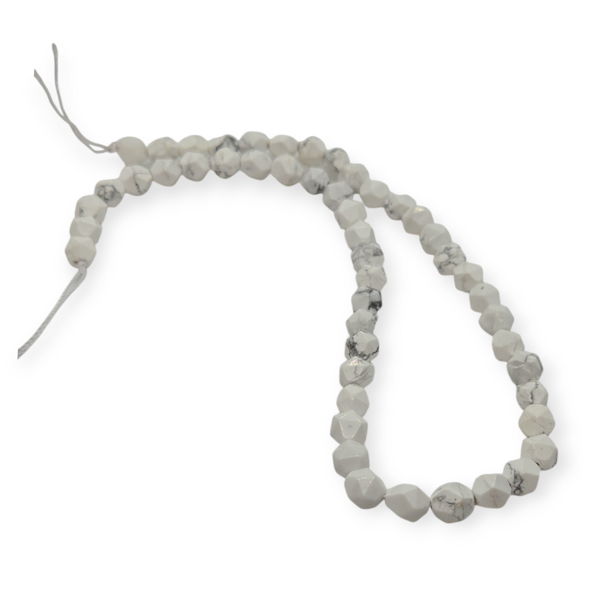 Howlite gemstone bead strand, faceted round beads with light speckled pattern.