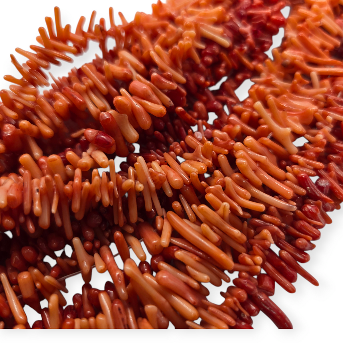 Red bamboo coral beads pile, natural orange-red cylinder shapes