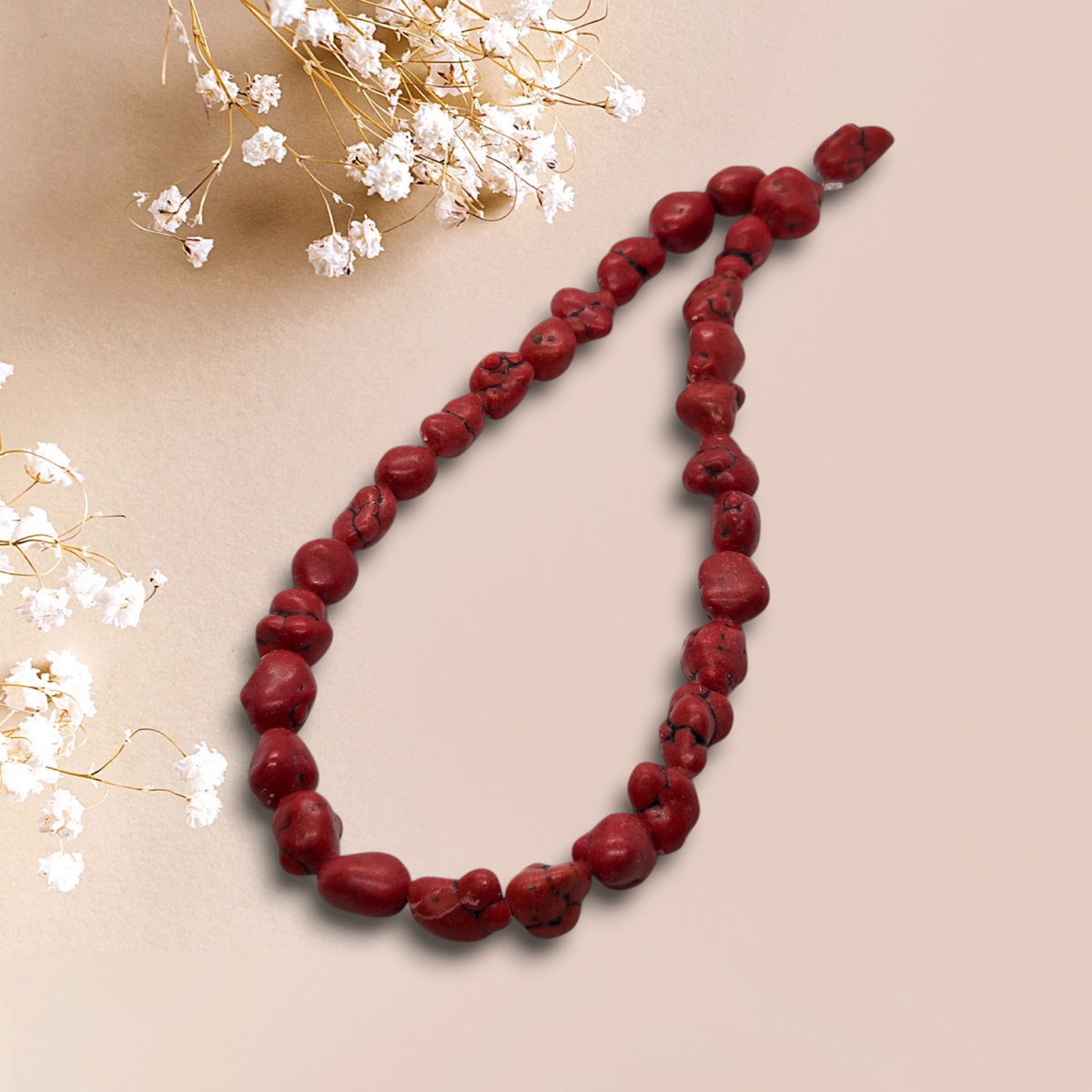 Red magnesite nugget bead strand, irregular dark-red beads, drilled holes