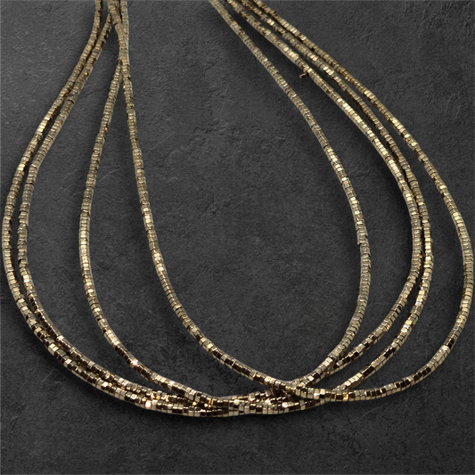 Gold-tone hexagon bead strands (2mm) with metallic black accents