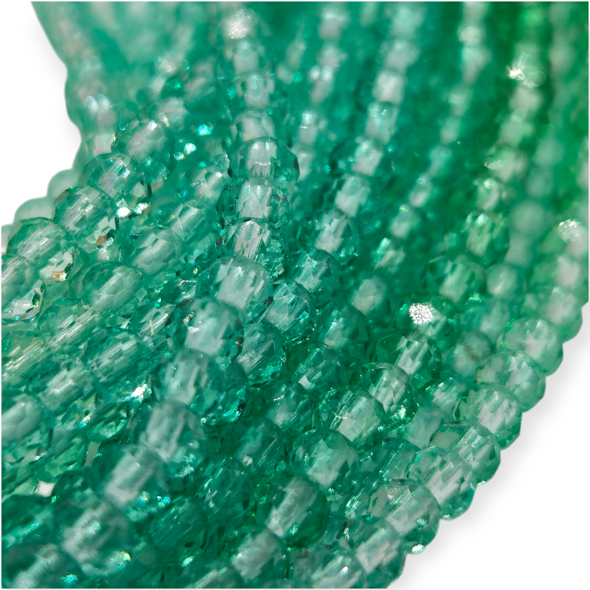 Transparent faceted glass rondelle beads close-up in green and clear