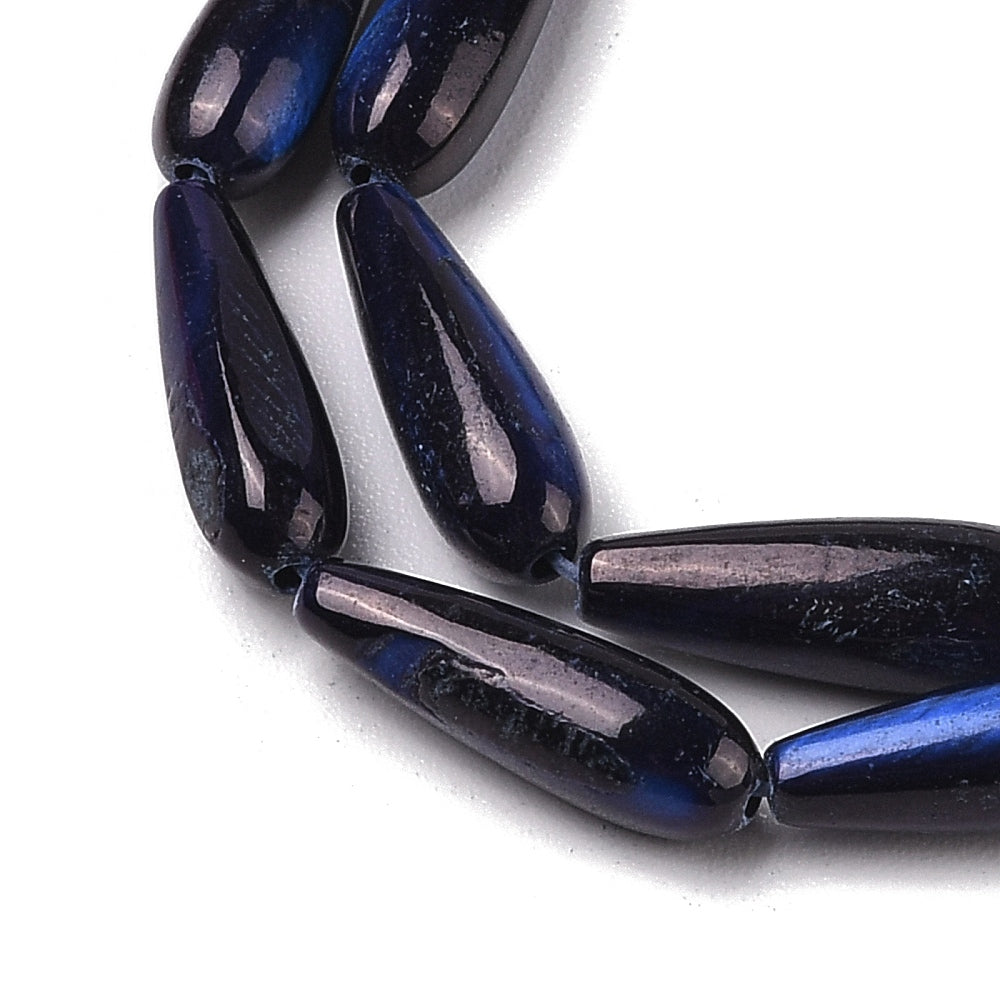 Close-up of midnight blue teardrop shell beads with iridescent blue streaks