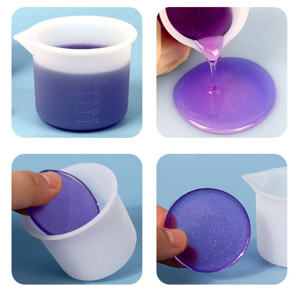 White silicone measuring cup pouring purple liquid; gloved hand using 50 ml graduations.
