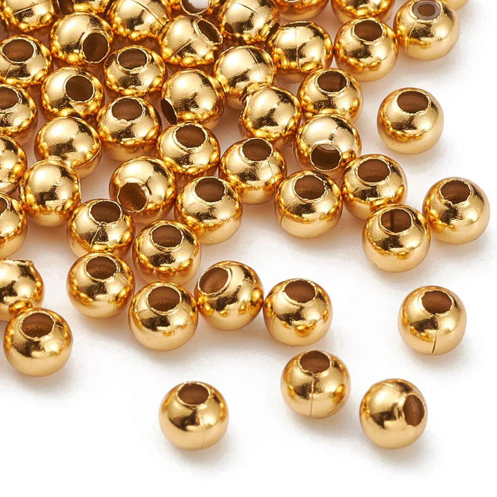 Round gold-plated beads, close view of smooth tops and drilled holes