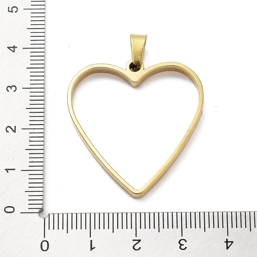 Heart bezel pendant next to ruler for size, gold-tone plated open back