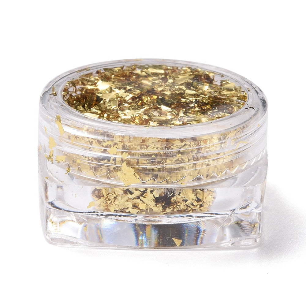 Gold metallic foil flakes in clear plastic storage jar