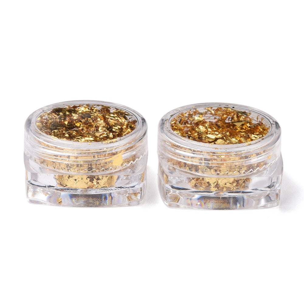 Golden metallic foil flakes in two closed clear mini jars