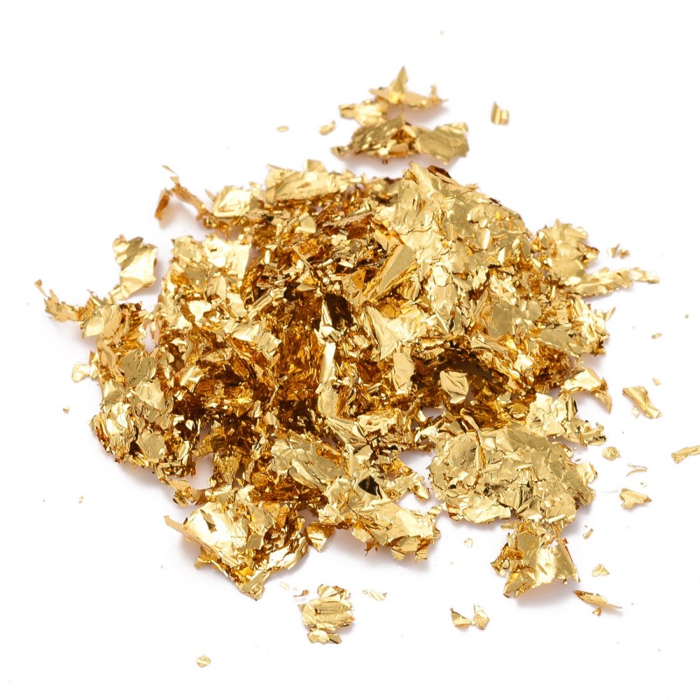 Loose golden metallic foil flakes pile