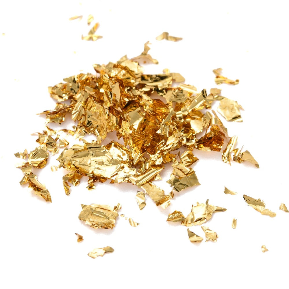 Scattered golden metallic foil flakes